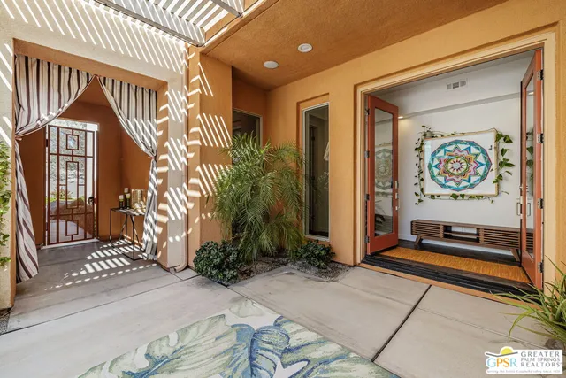 a view of a patio with couches table and chairs and potted plants
