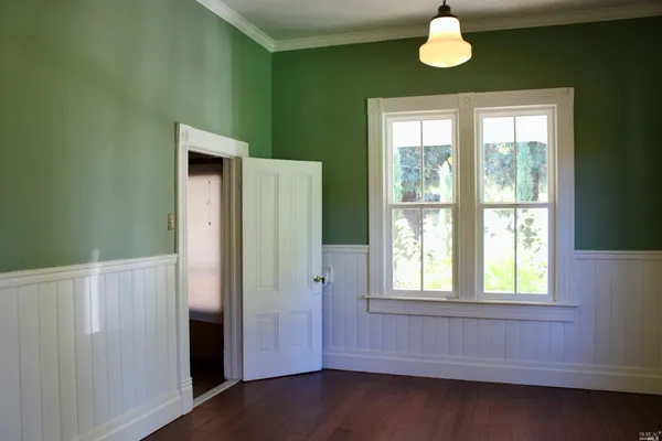 a view of empty room with windows and fan