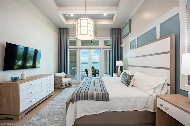 a bedroom with a large bed and a flat screen tv