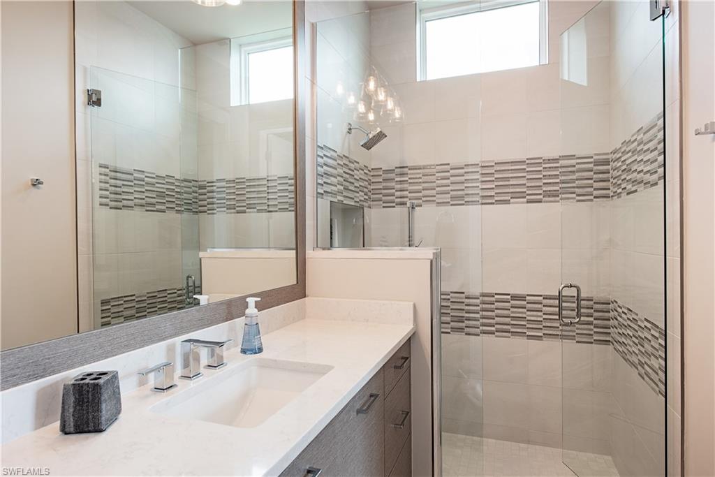 18354 Blue Eye Loop Fort Myers, FL 33913 - Photo 14 of 27 a bathroom with a sink and a mirror