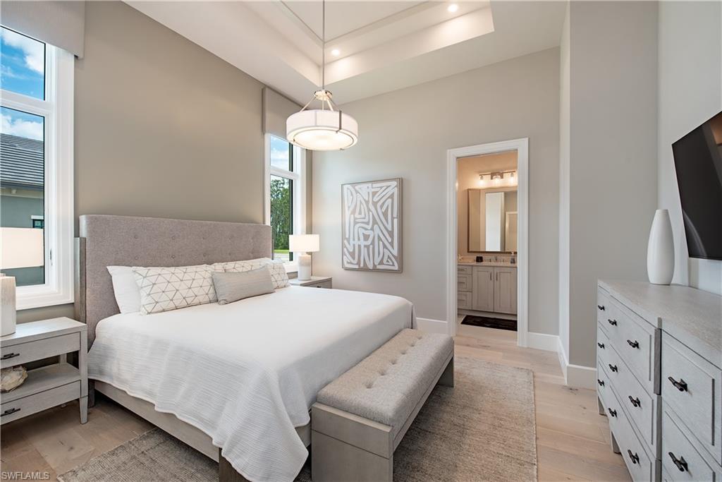 18354 Blue Eye Loop Fort Myers, FL 33913 - Photo 15 of 27 a spacious bedroom with a bed and a flat tv screen on dresser