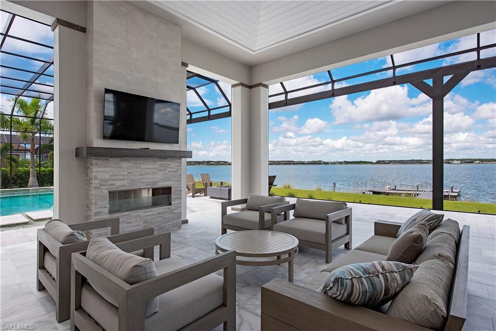 18354 Blue Eye Loop Fort Myers, FL 33913 - Photo 18 of 27 a living room with furniture a fireplace and a flat screen tv