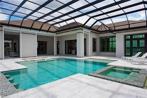 a view of a house with backyard porch and sitting area