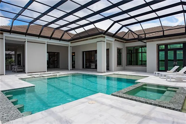 a view of a house with backyard porch and sitting area