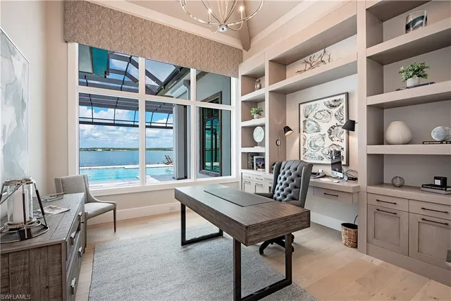 a view of a workspace with furniture and window