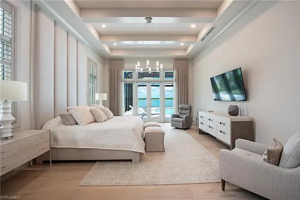 a bedroom with bed couch and window