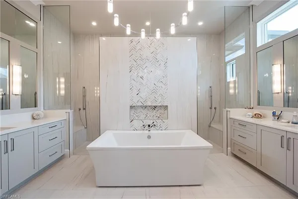 a spacious bathroom with a double vanity sink a mirror and a shower