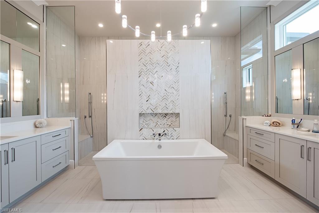 18354 Blue Eye Loop Fort Myers, FL 33913 - Photo 10 of 27 a spacious bathroom with a double vanity sink a mirror and a shower