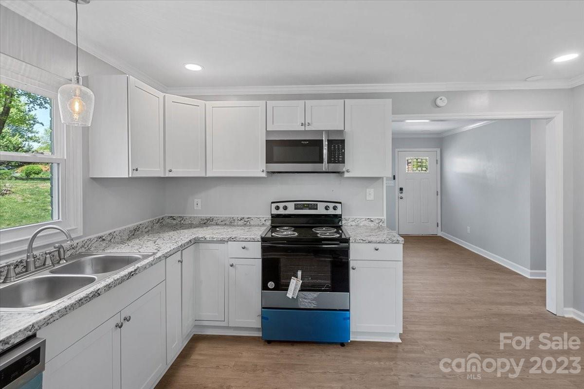 1500 Plumstead Road Charlotte, NC 28216 - Photo 12 of 30 a kitchen with stainless steel appliances granite countertop a stove and a sink