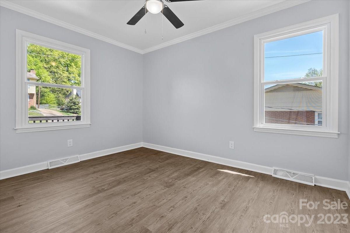1500 Plumstead Road Charlotte, NC 28216 - Photo 16 of 30 a view of an empty room with wooden floor and a window