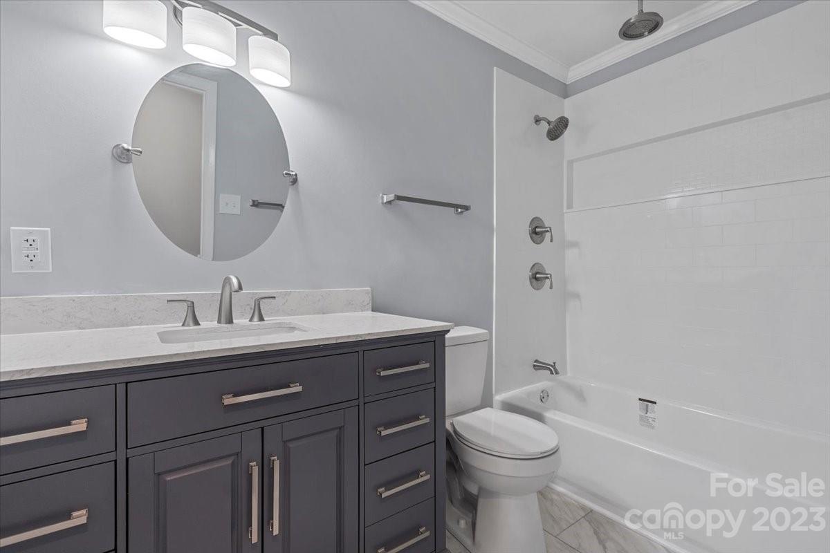 1500 Plumstead Road Charlotte, NC 28216 - Photo 17 of 30 a bathroom with a toilet a sink a mirror and bathtub