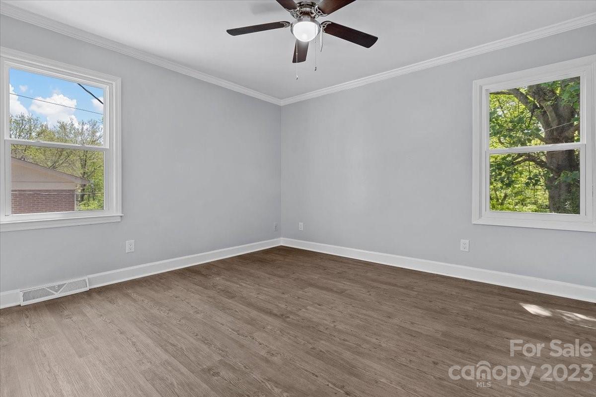 1500 Plumstead Road Charlotte, NC 28216 - Photo 18 of 30 a view of an empty room with wooden floor and a window