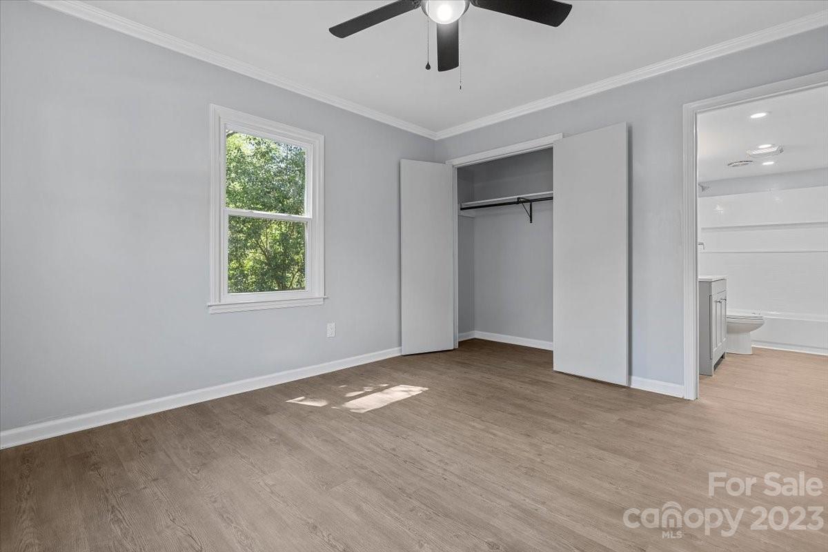 1500 Plumstead Road Charlotte, NC 28216 - Photo 25 of 30 an empty room with fan and windows