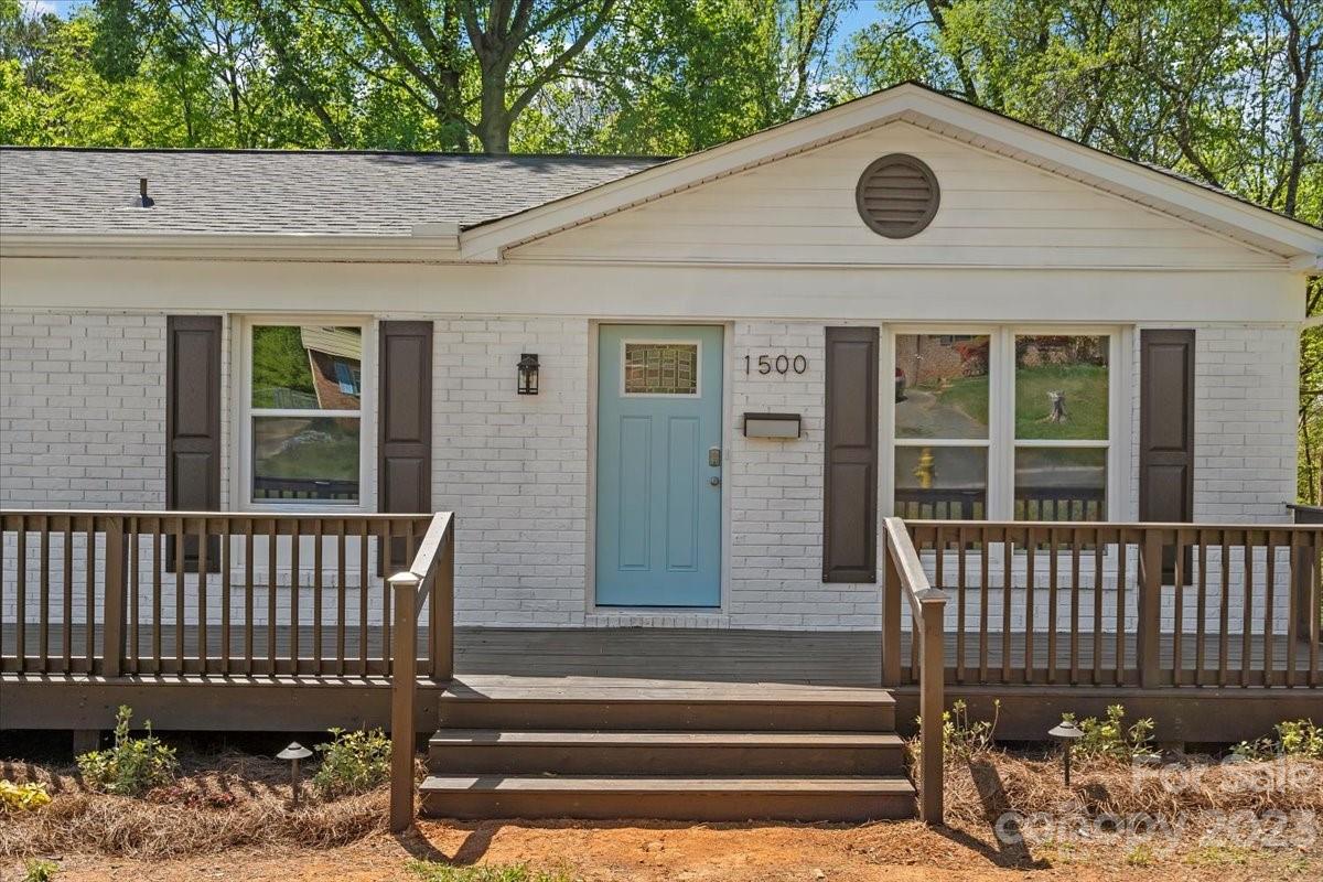 1500 Plumstead Road Charlotte, NC 28216 - Photo 3 of 30 a view of a house with a small yard and wooden fence