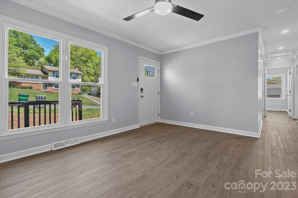 1500 Plumstead Road Charlotte, NC 28216 - Photo 8 of 30 an empty room with wooden floor and windows