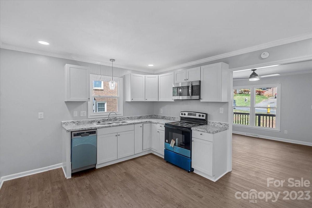 1500 Plumstead Road Charlotte, NC 28216 - Photo 10 of 30 a kitchen with stainless steel appliances granite countertop a stove and a sink