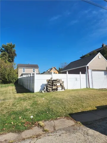 a view of a house with a yard and garage