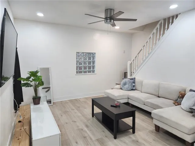 a living room with furniture and a potted plant