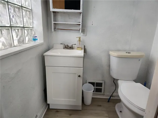 a white toilet sitting next to a bathroom sink