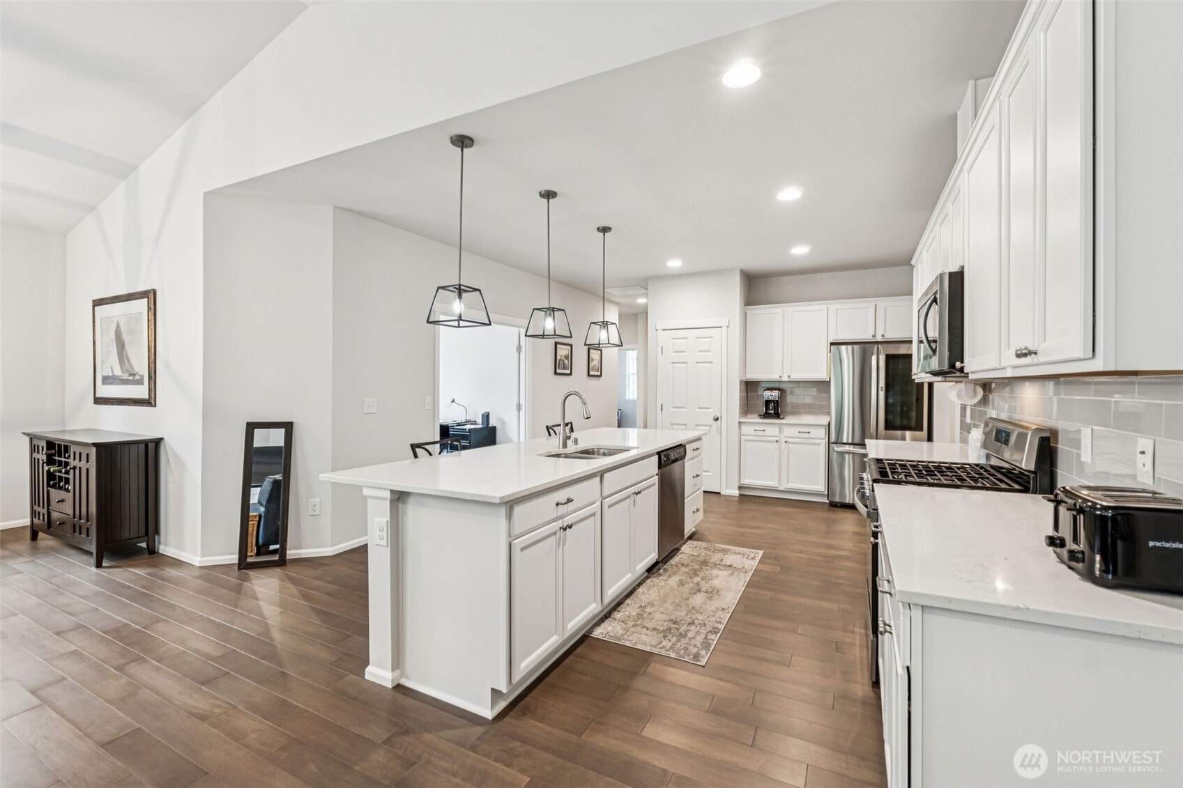 1028 Alpine View Drive Mount Vernon, WA 98274 - Photo 12 of 27 a large kitchen with stainless steel appliances kitchen island granite countertop a stove a sink a refrigerator and white cabinets with wooden floor