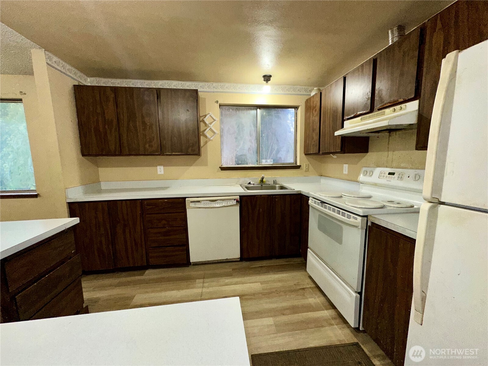 3936 Southwest 332nd Place Federal Way, WA 98023 - Photo 17 of 28 a kitchen with stainless steel appliances granite countertop wooden cabinets a stove top oven a sink and dishwasher