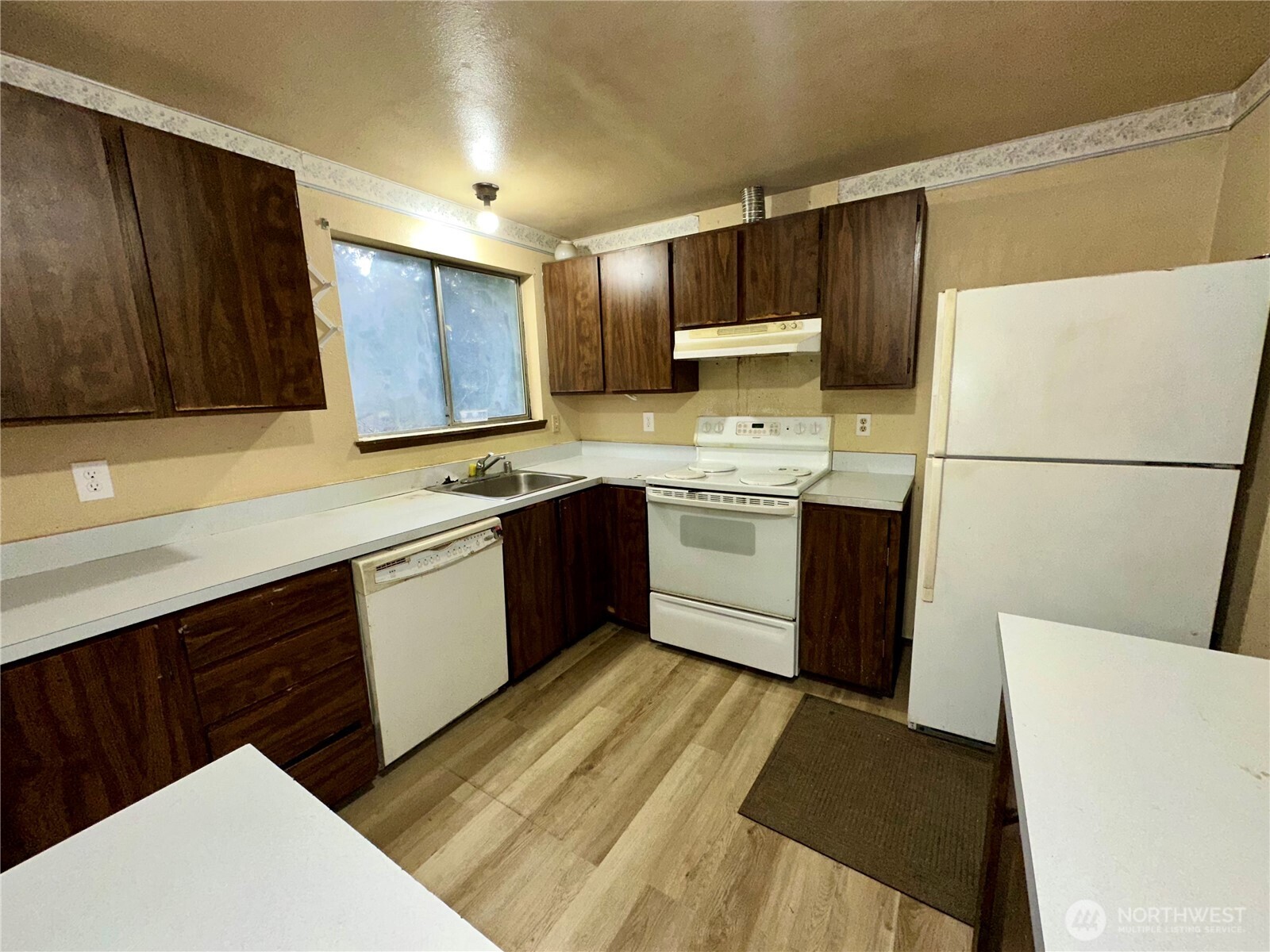 3936 Southwest 332nd Place Federal Way, WA 98023 - Photo 18 of 28 a kitchen with a sink a stove a refrigerator and cabinets