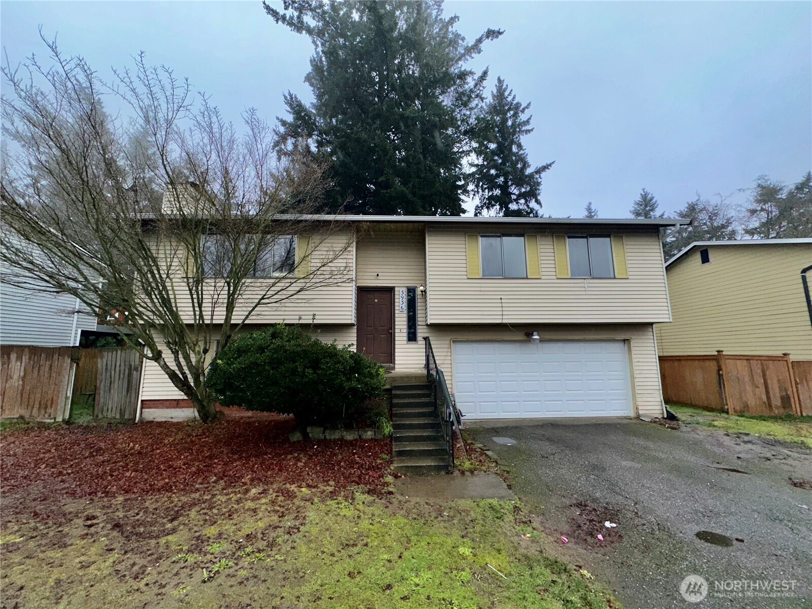 3936 Southwest 332nd Place Federal Way, WA 98023 - Photo 4 of 28 a front view of a house with a yard and garage