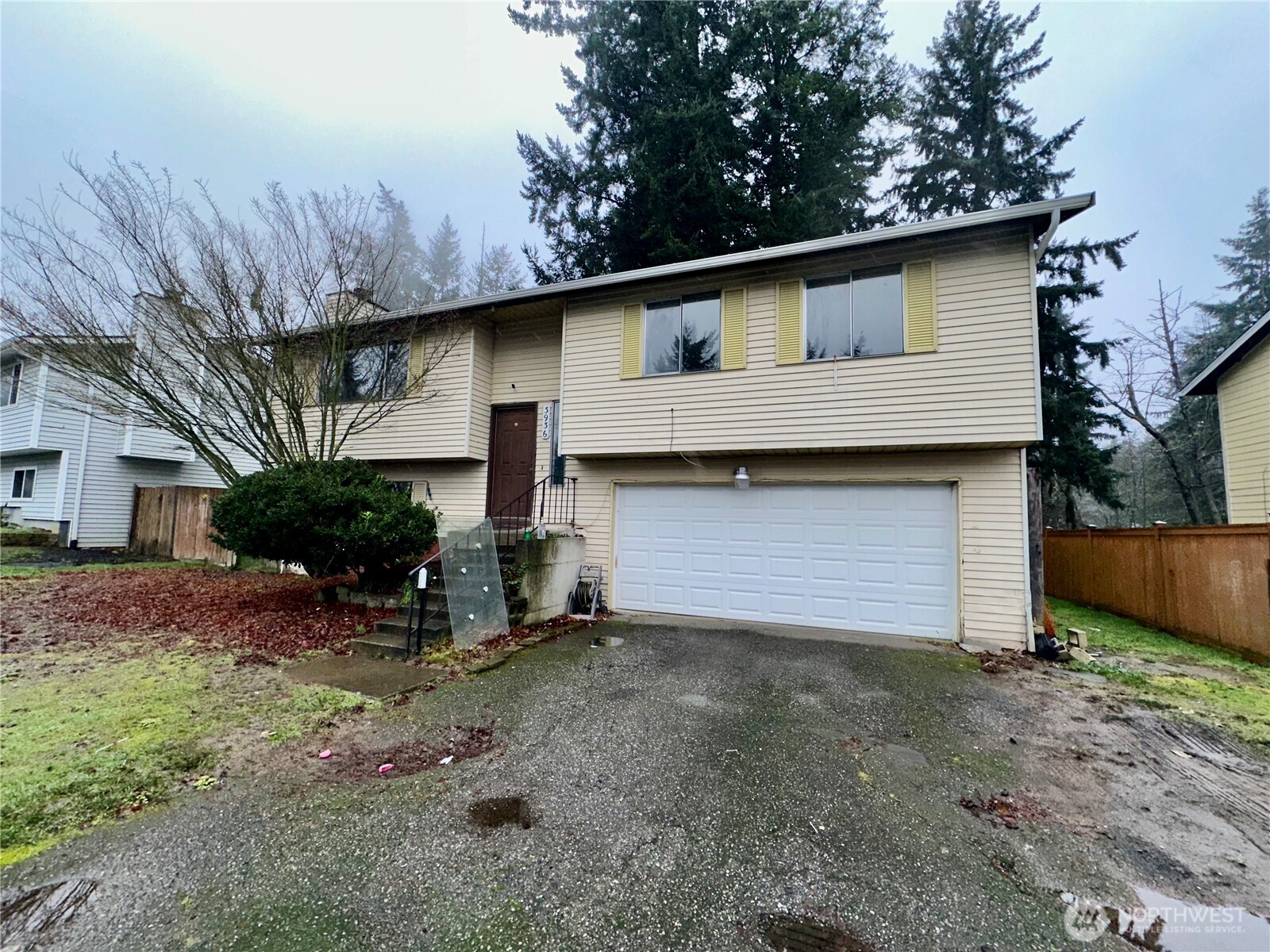 3936 Southwest 332nd Place Federal Way, WA 98023 - Photo 5 of 28 a front view of house with yard and trees in the background