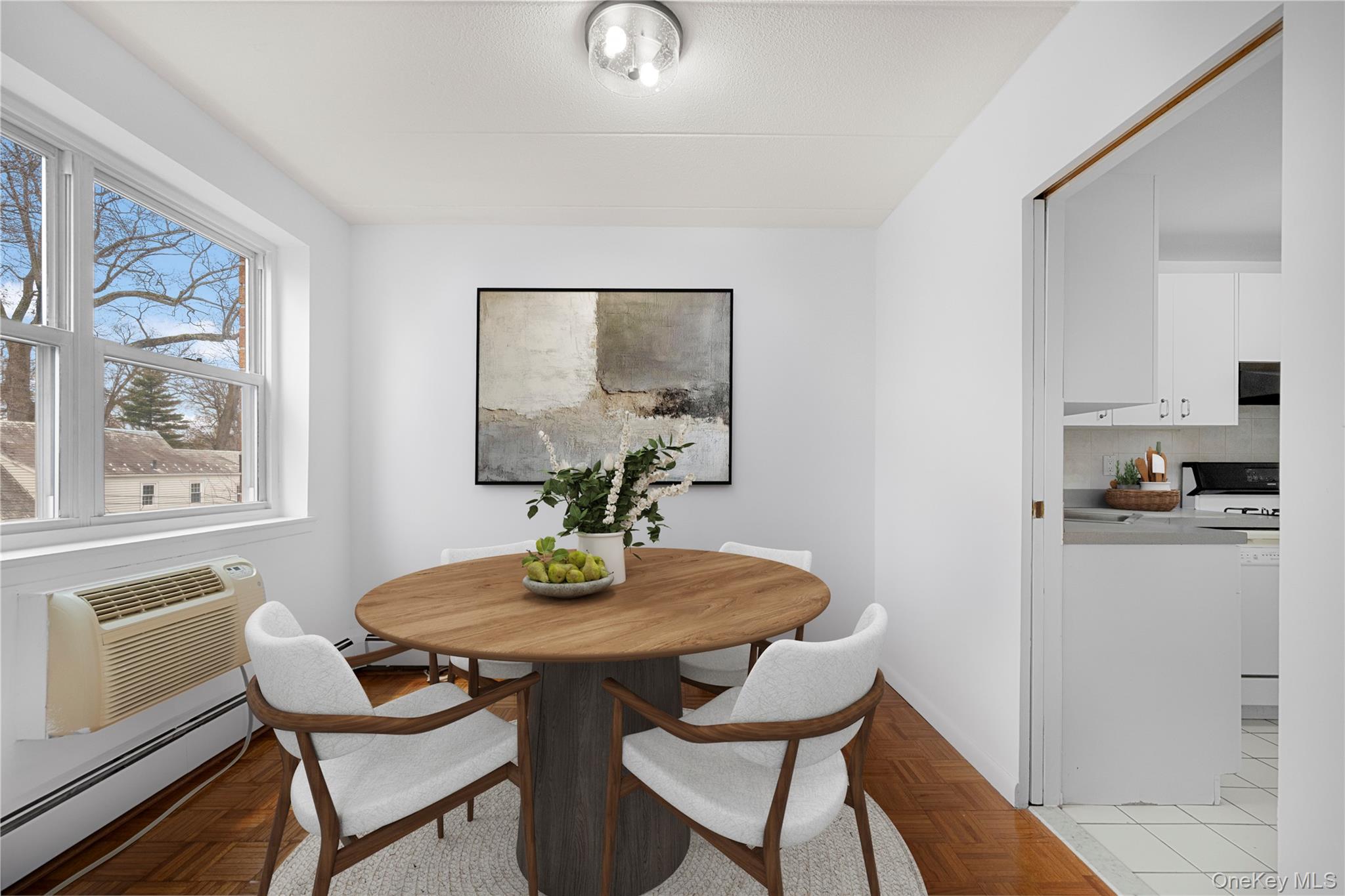 10 Ipswich Avenue, Unit 4M Great Neck, NY 11021 - Photo 6 of 25 a view of a dining room with furniture window and wooden floor