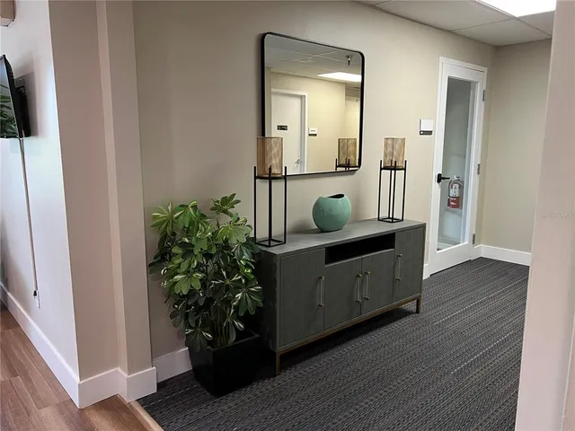 a view of a livingroom with a chair and a ceiling fan