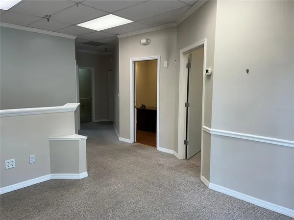 a view of a dining room with furniture and a window