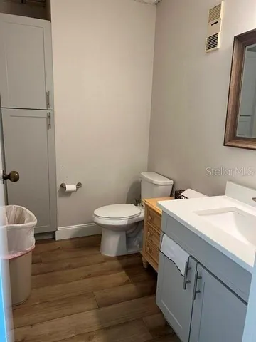 an empty room with wooden floor and closet
