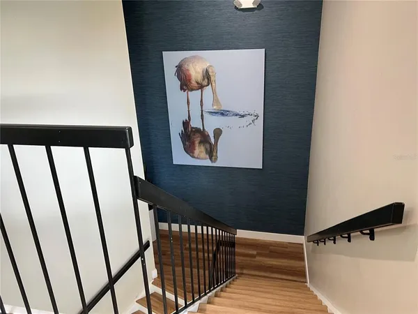 a view of a hallway with wooden floor and closet