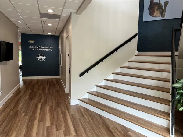 a view of a house with a yard and palm tree