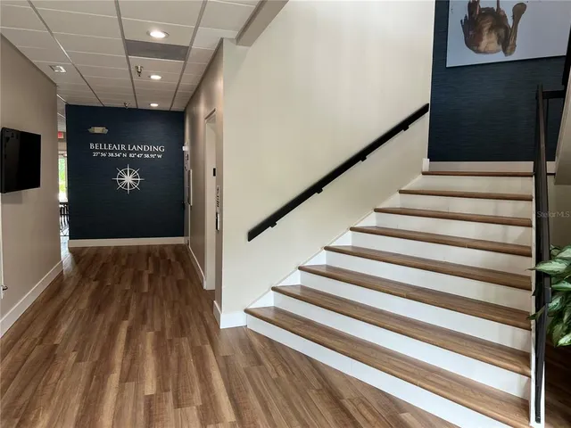 a view of a house with a yard and palm tree