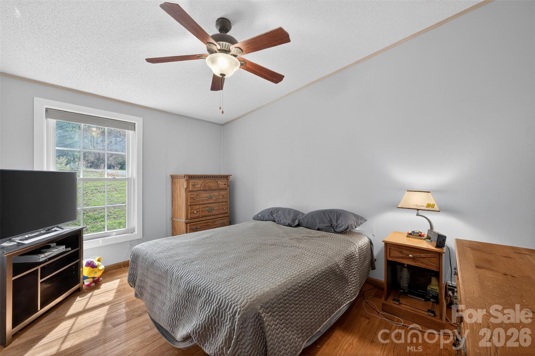4352 Anderson Mountain Road Maiden, NC 28650 - Photo 30 of 42 a bedroom with a bed and a flat screen tv