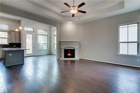 a view of an empty room with a fireplace and a window