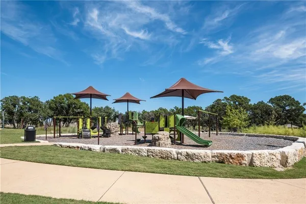 a view of a park with couches and table