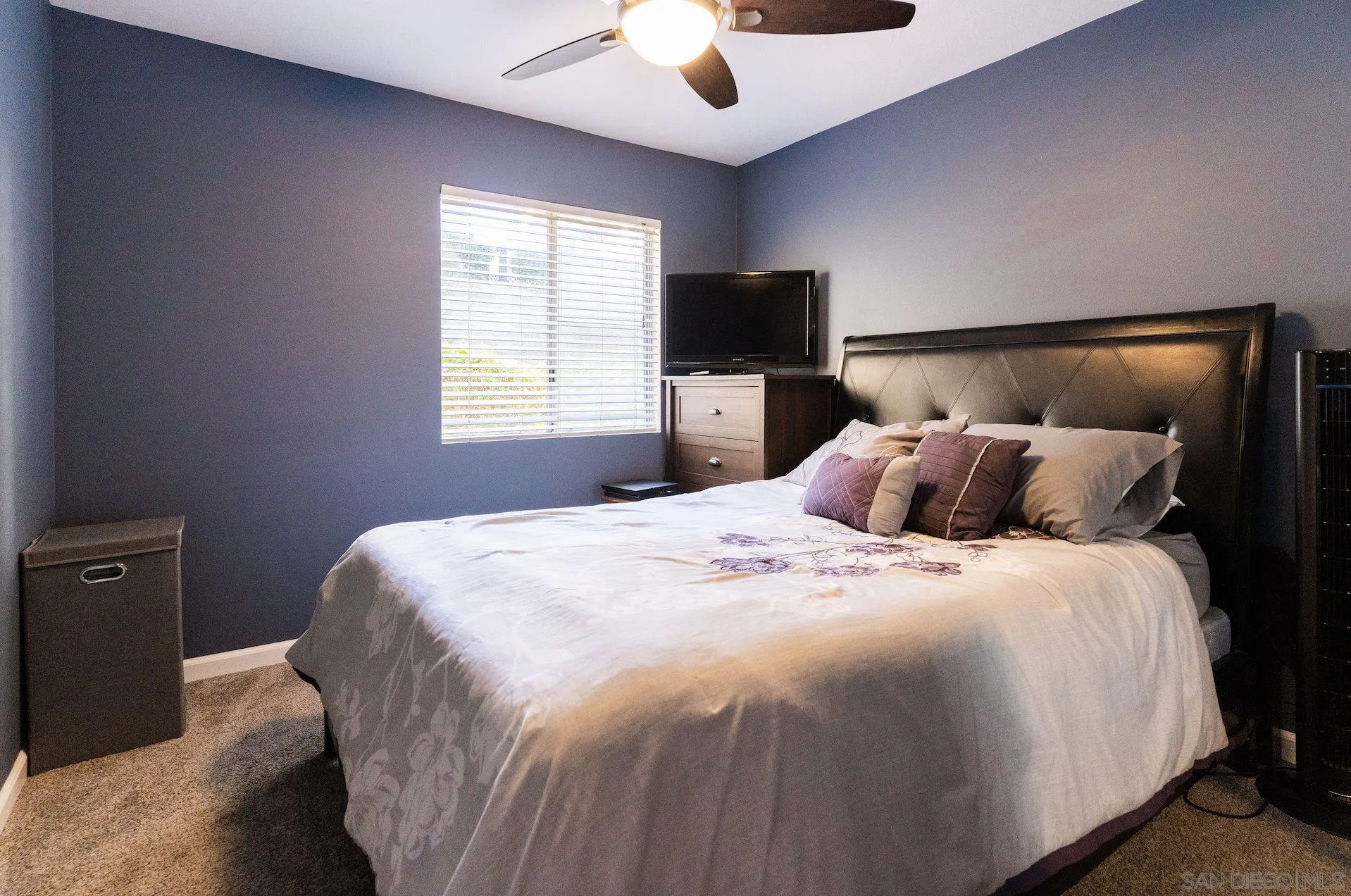 730 Brookstone Road, Unit 103 Eastlake, CA 91913 - Photo 10 of 25 a bedroom with a bed and a flat tv screen on dresser