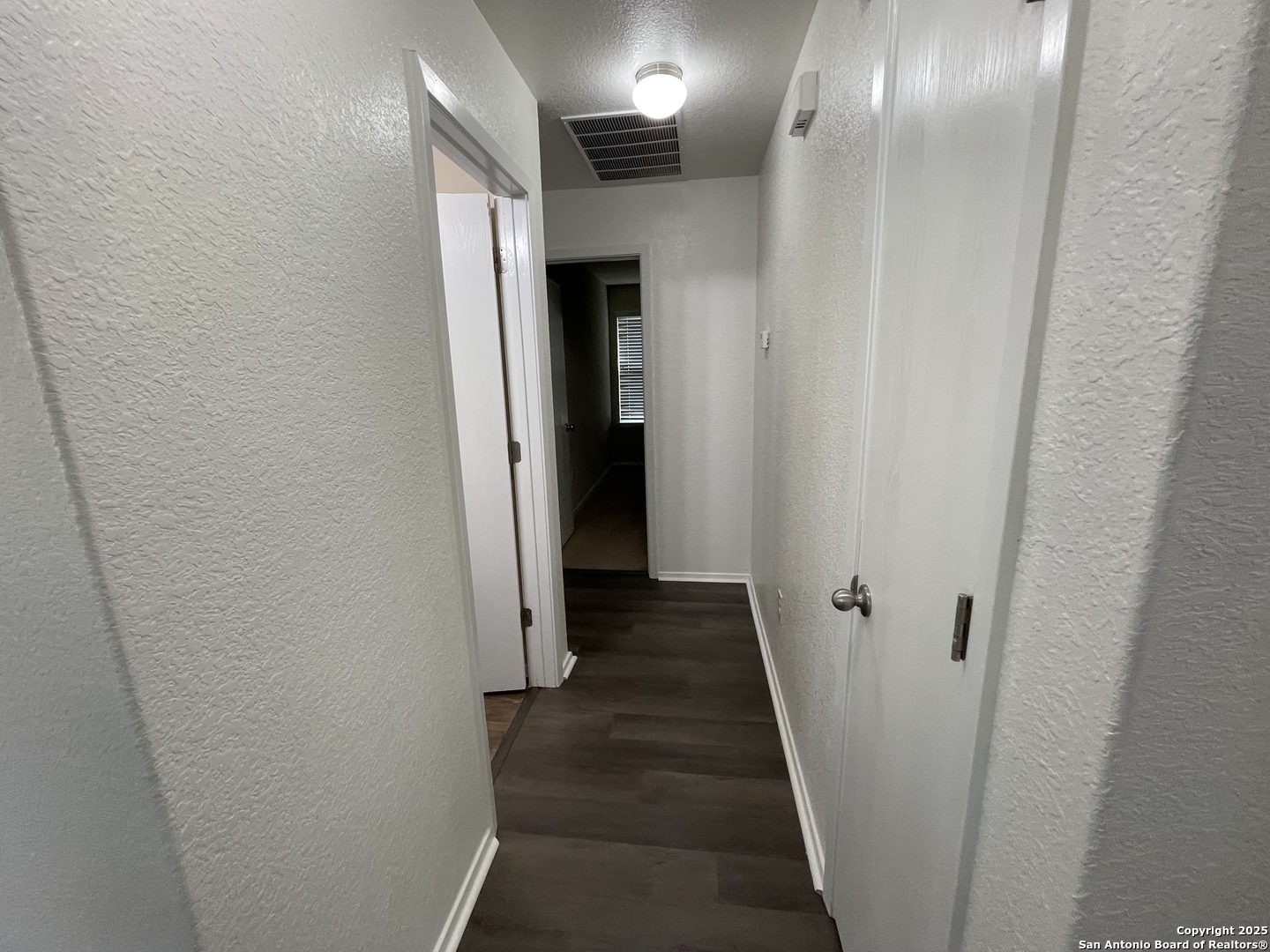 10014 Raspberry Oak San Antonio, TX 78223 - Photo 14 of 20 a view of a hallway with a wooden floor