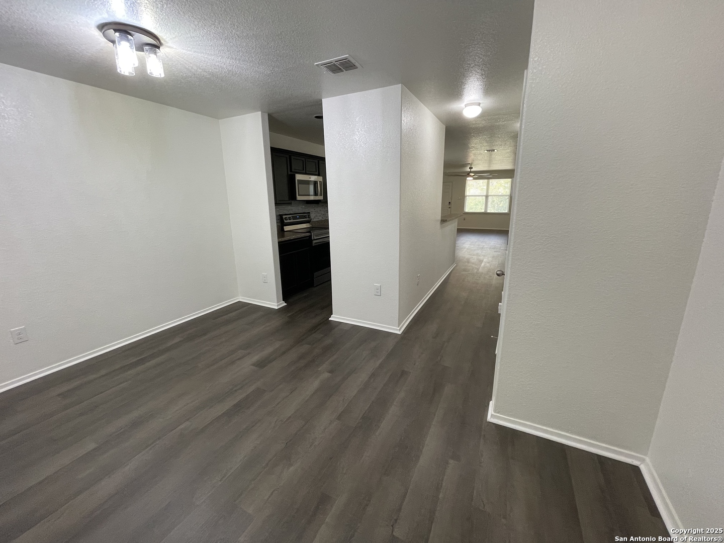 10014 Raspberry Oak San Antonio, TX 78223 - Photo 4 of 20 wooden floor in an empty room with a window