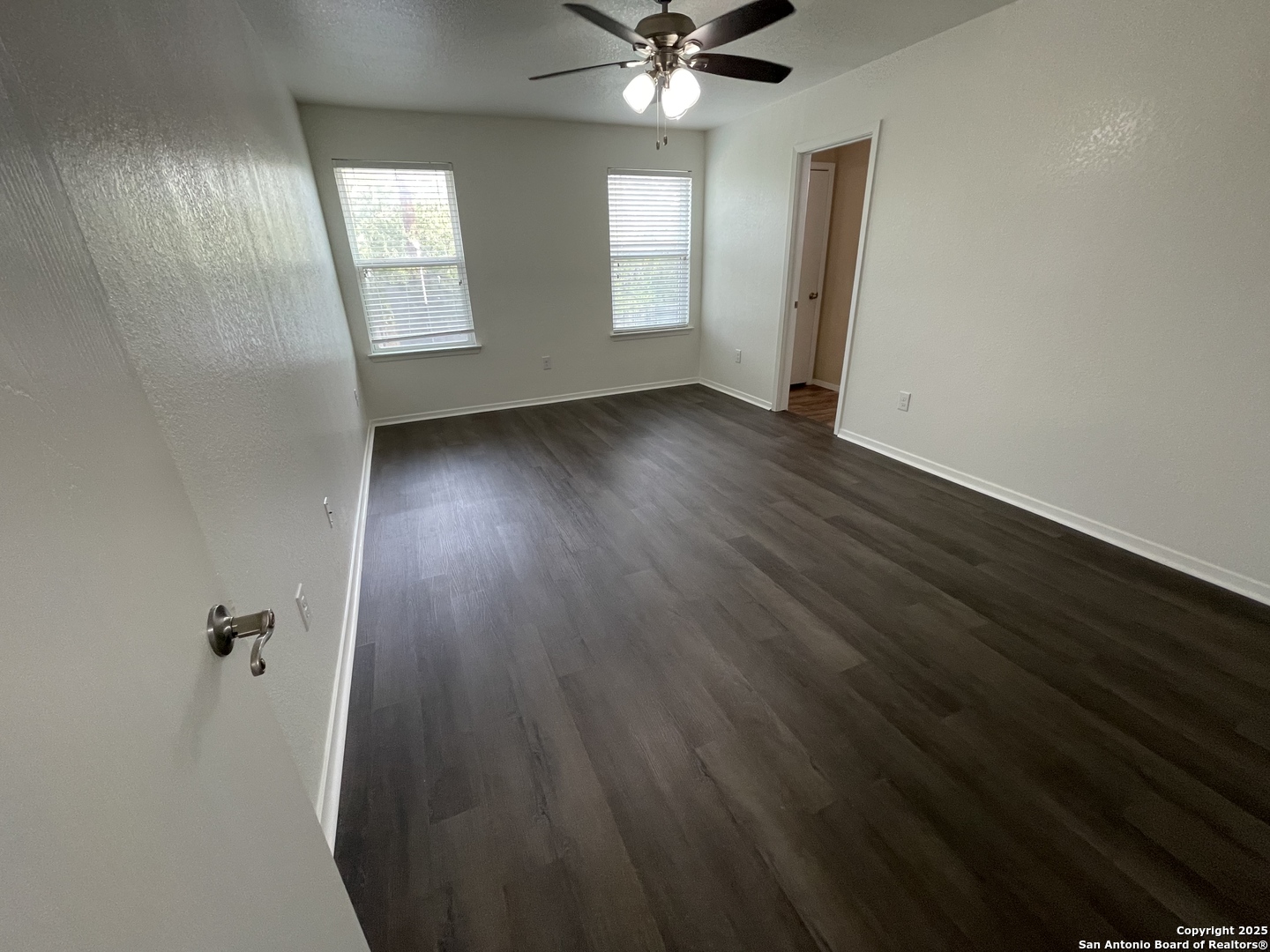 10014 Raspberry Oak San Antonio, TX 78223 - Photo 8 of 20 an empty room with wooden floor fan and windows