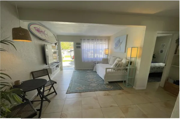 a living room with furniture and a rug