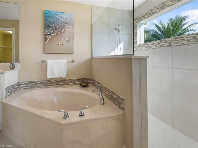 a bathroom with a tub and shower