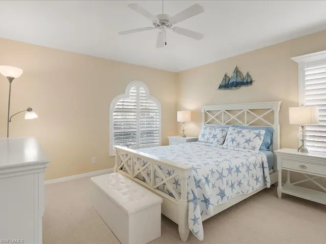 a bedroom with a bed a couch and a window