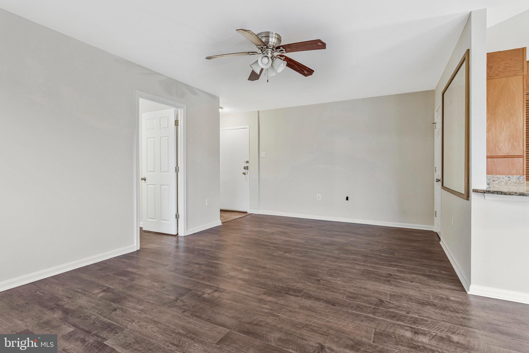 3802 Bel Pre Road, Unit 38025 Silver Spring, MD 20906 - Photo 11 of 36 an empty room with wooden floor and ceiling fan