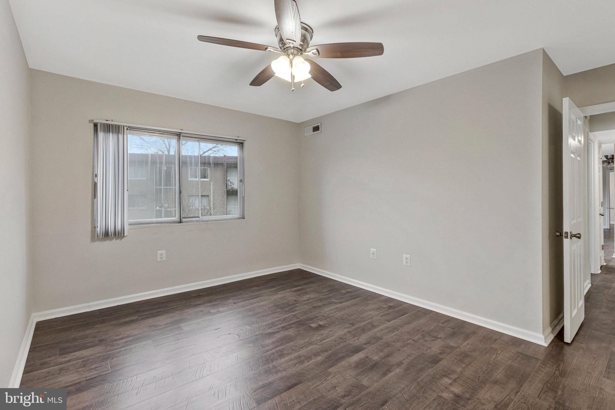 3802 Bel Pre Road, Unit 38025 Silver Spring, MD 20906 - Photo 30 of 36 wooden floor in an empty room with a window