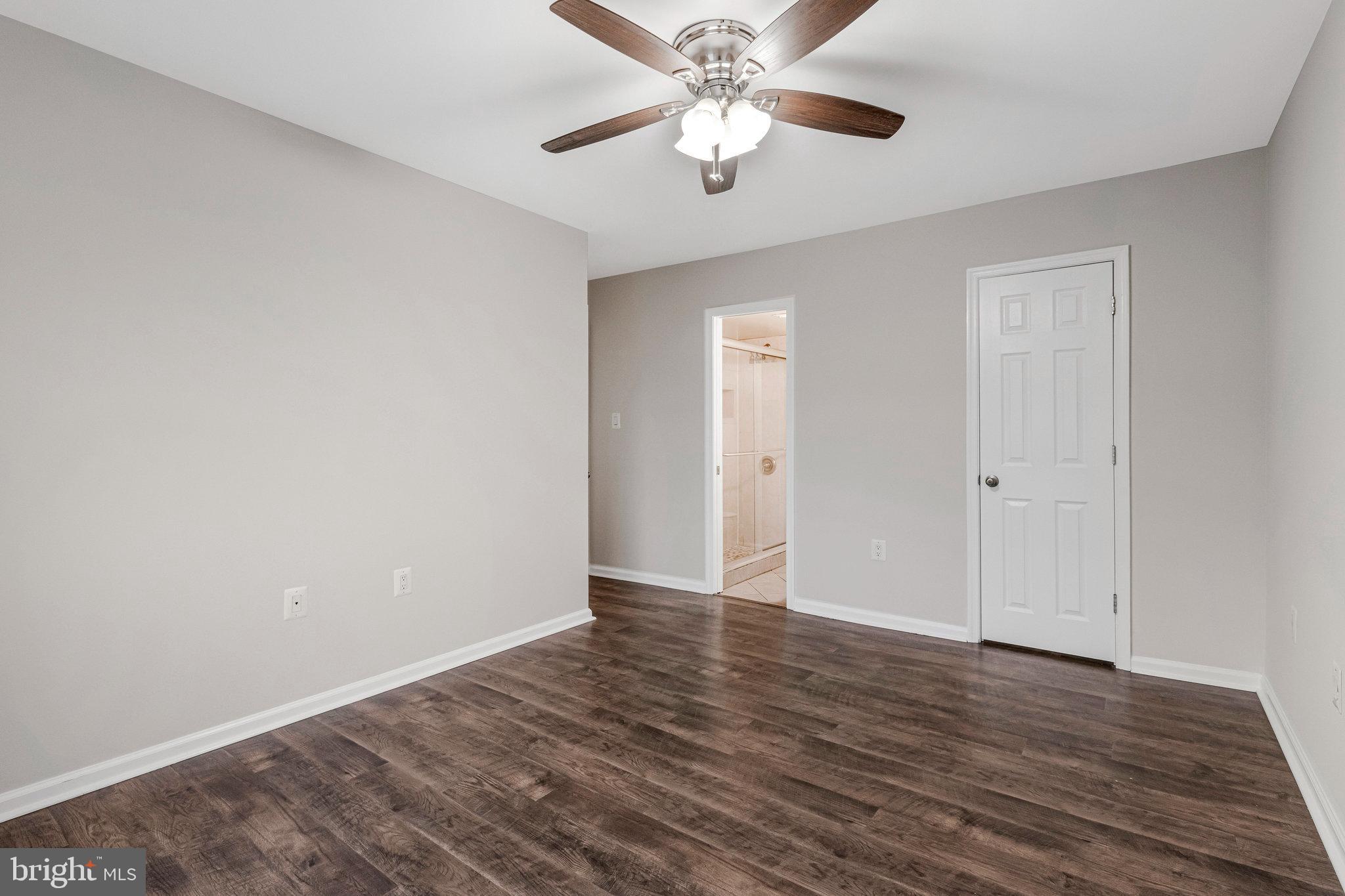 3802 Bel Pre Road, Unit 38025 Silver Spring, MD 20906 - Photo 31 of 36 a view of an empty room with wooden floor