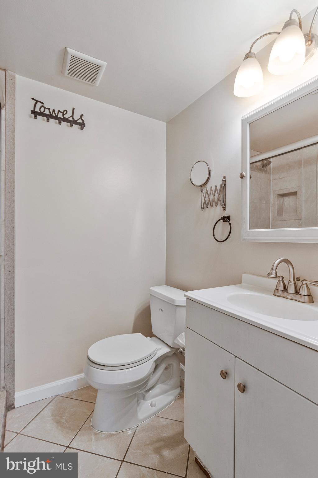 3802 Bel Pre Road, Unit 38025 Silver Spring, MD 20906 - Photo 33 of 36 a bathroom with a toilet a sink and mirror
