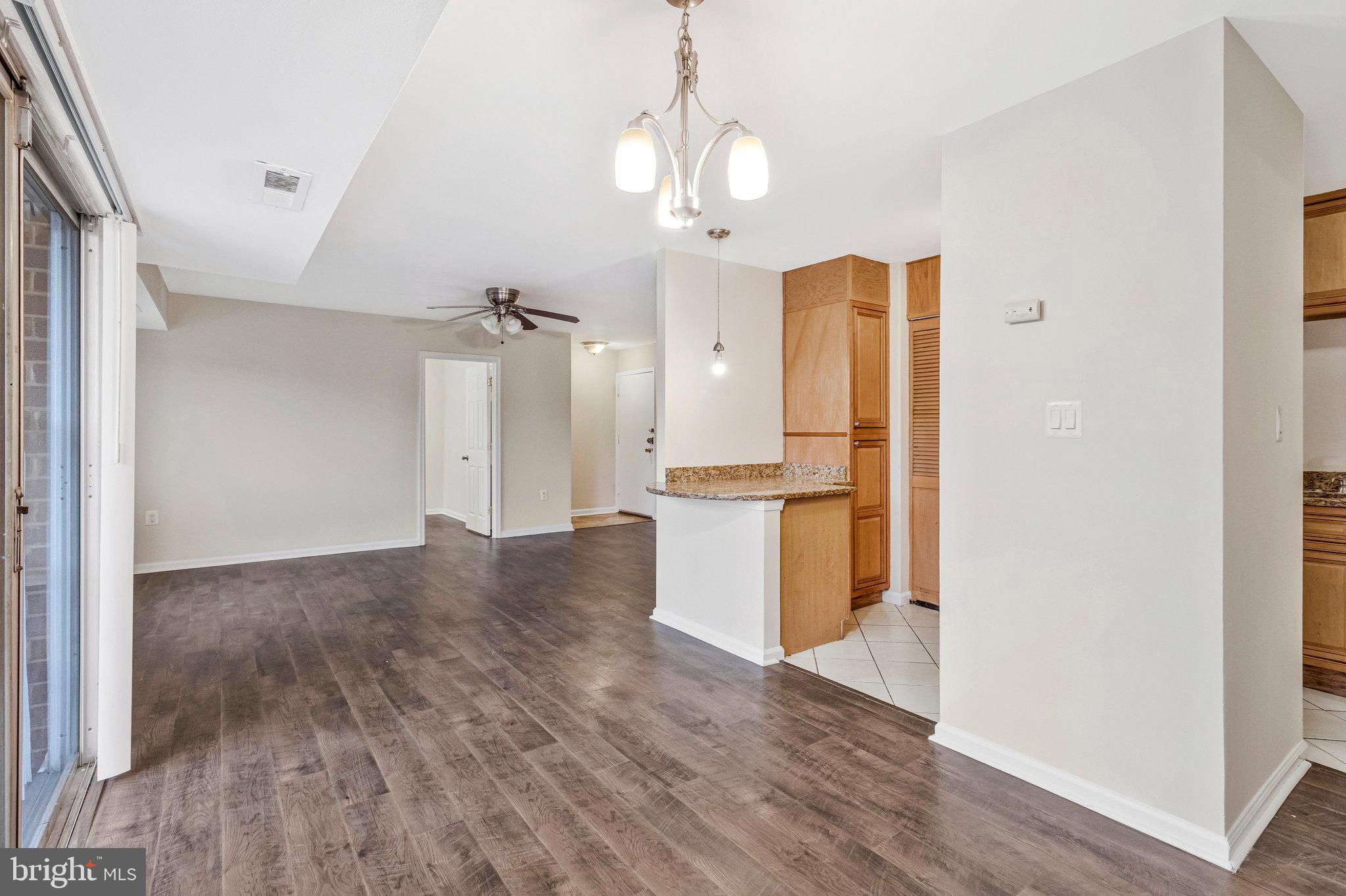 3802 Bel Pre Road, Unit 38025 Silver Spring, MD 20906 - Photo 10 of 36 a view of a kitchen with wooden floor